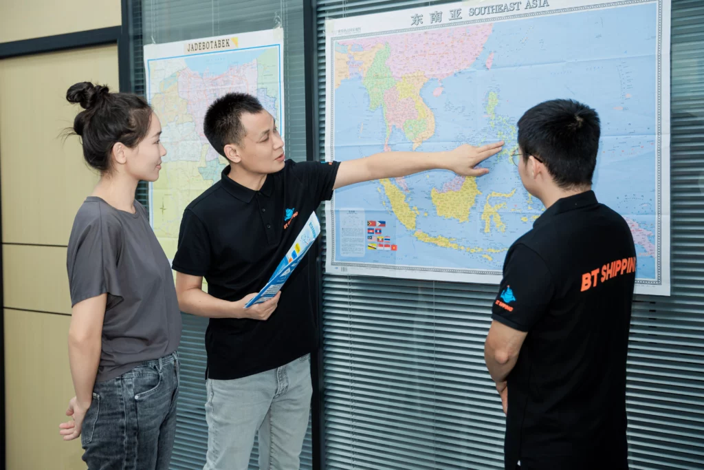 Employees discussing in front of a map